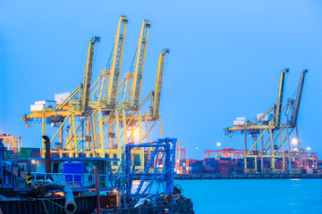 Containers loading by crane in the night , Trade Port , Shipping

