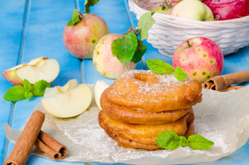 Apples fried in a batter with cinnamon and powdered sugar