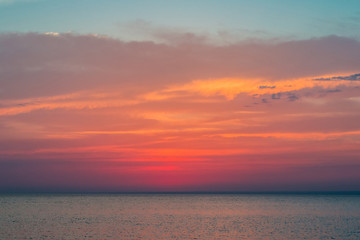 Beautiful sunset over the Black Sea in the summer.The bird flying over water. Sea landscape. Nature composition