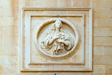 Women's bas-relief on the wall of house