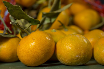 Heap of citrus fruits that get out of an overturned red sack