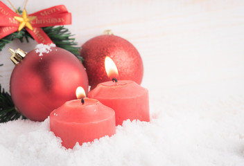 Red christmas balls and advent candle,wood blackground