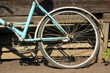 Fototapeta na wymiar Rear wheel old vintage bike. Retro bicycle standing at the woode