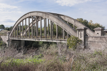 Fototapeta na wymiar An ancient symbol of the fascist era bridge