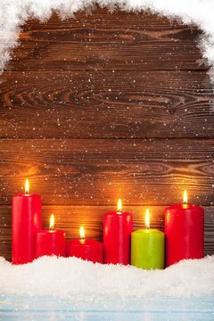 Christmas background with candles in snow