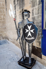 Maltese knight at the shop entrance