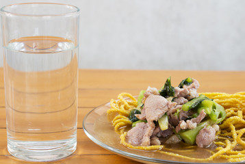 Thailand Fried noodle soup, vegetables and drinking water on the table.
