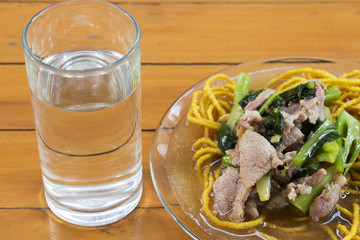 Thailand Fried noodle soup, vegetables and drinking water on the table.