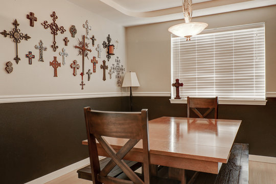 Pastoral style dining room. Crosses hanging on the wall