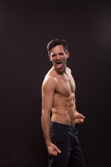 Fototapeta premium young man silly expression tongue posing