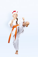 In the cap of Santa Claus girl is training kick leg