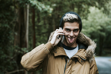 boy with mobile phone in the forest