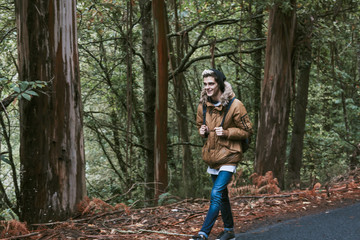 boy walking down the mountain with backpack