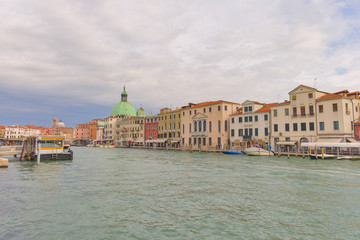 Fototapeta na wymiar Cityscape view on the Grand canal with dome of San Piccolo Simeone church in Venice