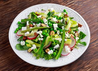 Fresh Green Asparagus salad witch Goat Cheese, peas, radishe, zucchini, lettuce and Hazelnuts.