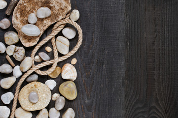 Stones and rope on the wooden background