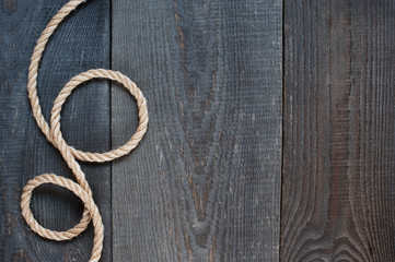 Rope on the old wooden background