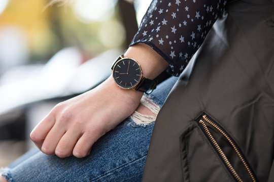 fall fashion outfit details. young businesswoman in elegant trendy clothing with accessories on hands. beautiful black and golden elegant watch.

