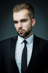 Handsome bearded man wearing suit, portrait shot in studio