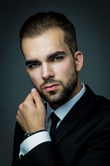 Handsome bearded man wearing suit, portrait shot in studio