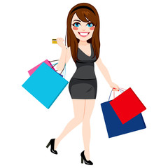 Beautiful young girl shopping holding paper bags and credit card
