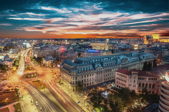 Aerial view of capital city Bucharest, Romania. University Square at sunset with traffic lights.