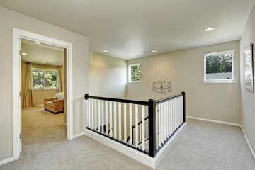 Bright beige hallway with carpet floor and stairacse
