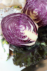 A head of purple cabbage cut in half on the board..