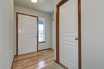 White walls hallway interior with hardwood floor