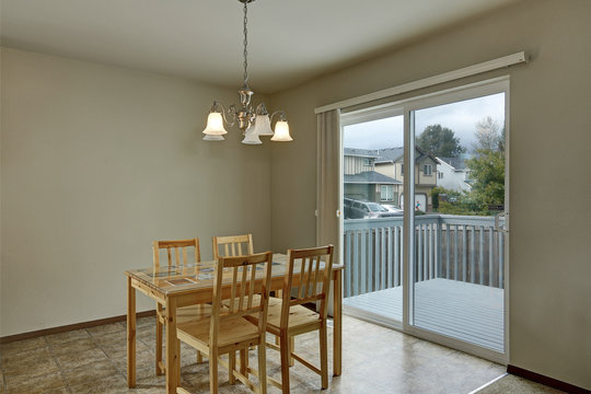 Dining area with wooden table and chair set. House interior