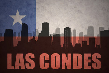 abstract silhouette of the city with text Las Condes at the vintage chilean flag