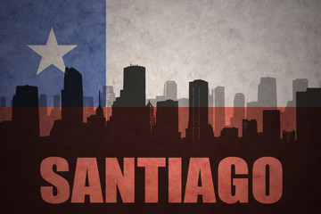 abstract silhouette of the city with text Santiago at the vintage chilean flag