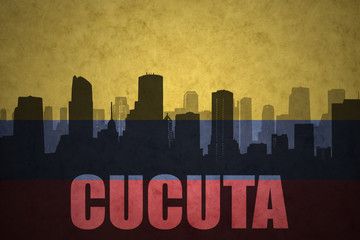 abstract silhouette of the city with text Cucuta at the vintage colombian flag