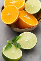 Mixed citrus fruit lemons, orange, kiwi, limes on a gray backgro