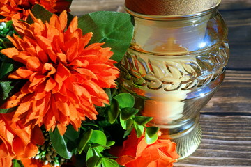 Bouquet of flowers and memorial candle, closeup view