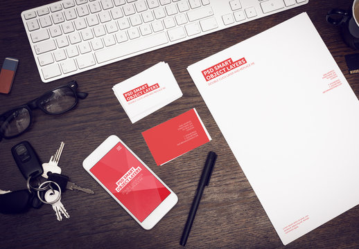 Smartphone and Stationery on Wooden Desk with Keys and Keyboard Mockup 1 - Red