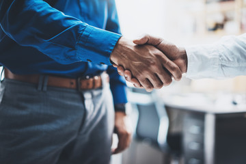 Business partnership handshake concept.Photo of two businessmans handshaking process.Successful deal after great meeting.Horizontal, blurred background.