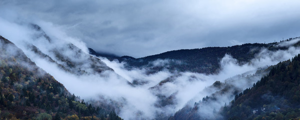 Clouds and autumnal colors in the Italian Alps