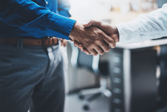 Business partnership handshake concept.Image of two businessmans handshaking process.Successful deal after great meeting.Horizontal, blurred background.