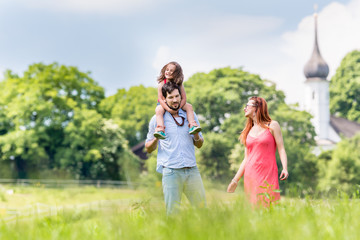 Obraz premium Family walking on meadow having walk