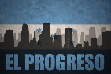Obraz premium abstract silhouette of the city with text El Progreso at the vintage honduras flag
