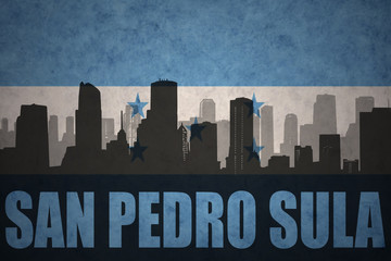 Fototapeta premium abstract silhouette of the city with text San Pedro Sula at the vintage honduras flag
