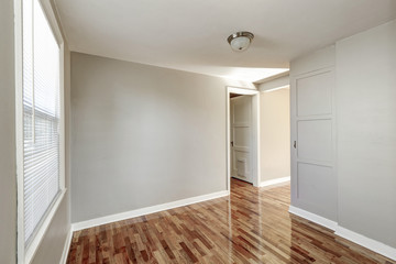 Empty beige hallway interior and hardwood floor