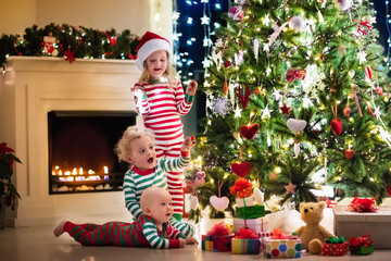 Kids in pajamas under Christmas tree