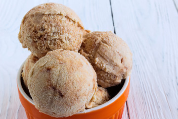 Homemade Ice cream with a persimmon, jam, cardamom on a white wo