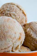 Homemade Ice cream with a persimmon, jam, cardamom on a white wo