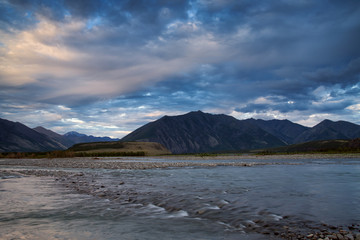 Wide and soft mountain river with rapids. Inyali River, a tributary of the Indigirka. Yakutia. Russia.