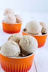 Homemade Ice cream with a persimmon, jam, cardamom on a white wo