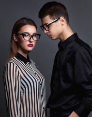 Fashion young couple in trendy glasses and stlylish clothes over