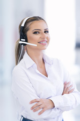 smiling female helpline operator with headphones